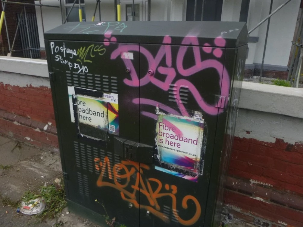 Green box showcasing before graffiti removal has taken place